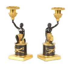 A PAIR OF FRENCH EMPIRE BRONZE AND ORMOLU BLACKAMOOR CANDLESTICKS