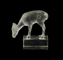 A LALIQUE CLEAR GLASS PAPERWEIGHT OF A DEER