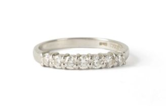 A 7-STONE DIAMOND AND PLATINUM HALF-ETERNITY RING