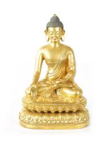 AN EARLY CAST GILT BRONZE TIBETAN BUDDHA