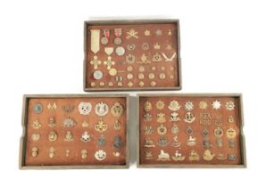 A LARGE COLLECTION OF MILITARY MEDALS AND HAT BADGES