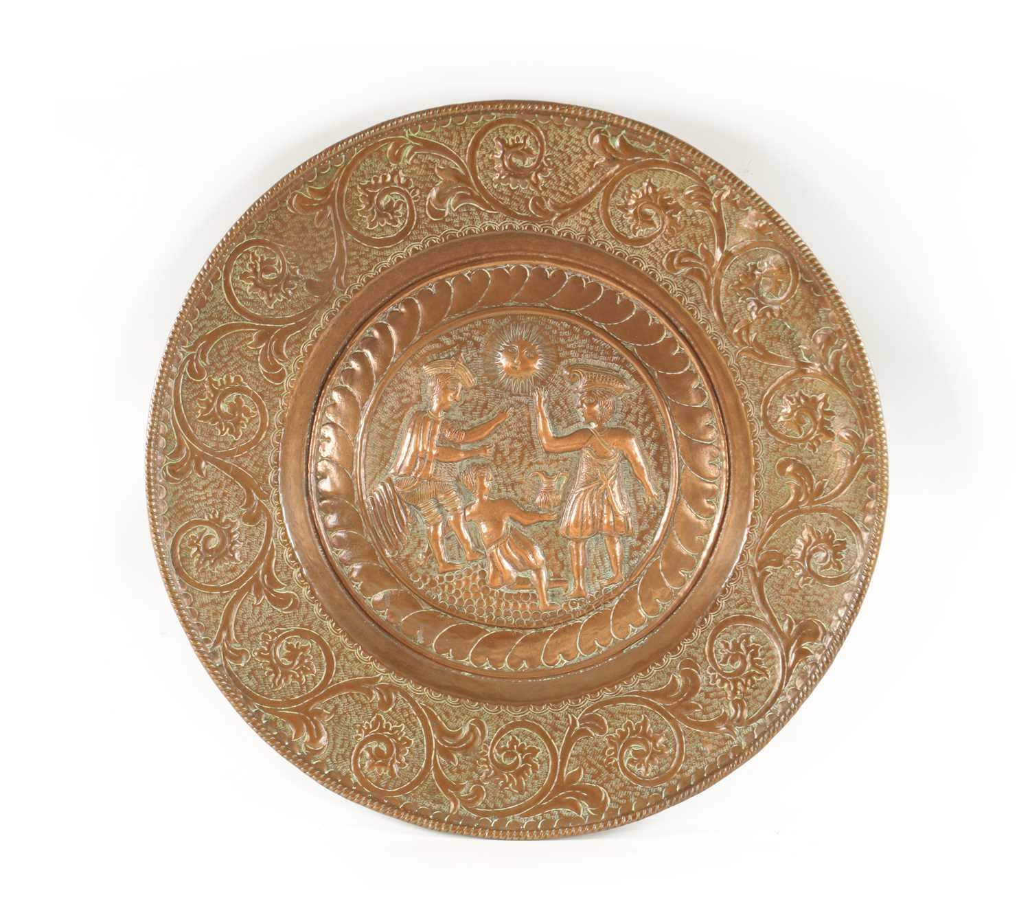 A 16TH / 17TH CENTURY EMBOSSED COPPER ALMS DISH OF LARGE SIZE