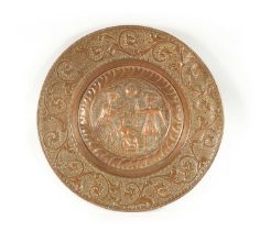 A 16TH / 17TH CENTURY EMBOSSED COPPER ALMS DISH OF LARGE SIZE