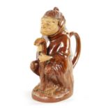 A 19TH CENTURY POTTERY MONKEY PITCHER JUG