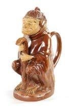 A 19TH CENTURY POTTERY MONKEY PITCHER JUG