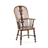 AN EARLY 19TH CENTURY NOTTINGHAMSHIRE YEW-WOOD HIGH BACK WINDSOR CHAIR
