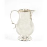 AN EARLY GEORGIAN SILVER CREAM JUG