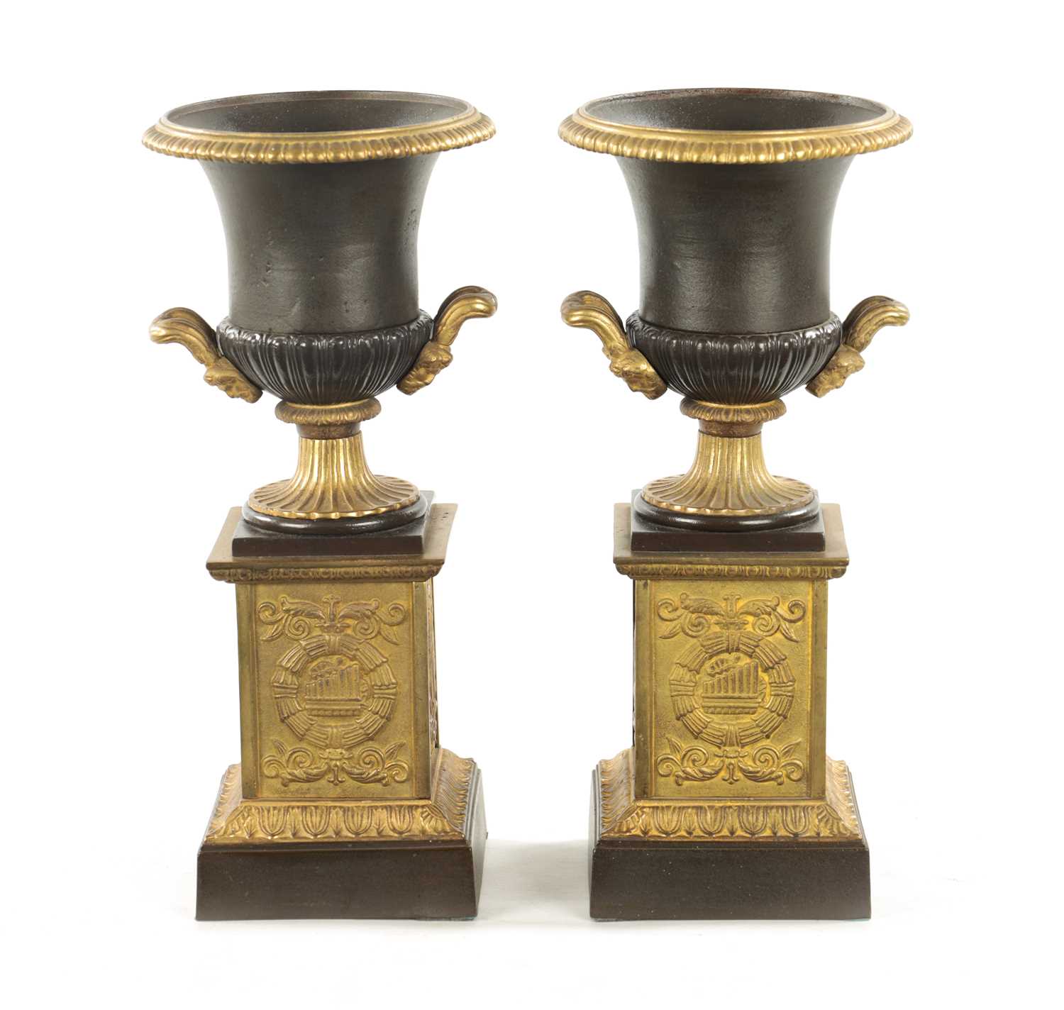 A PAIR OF 19TH CENTURY BRONZED GILT CAST IRON URNS