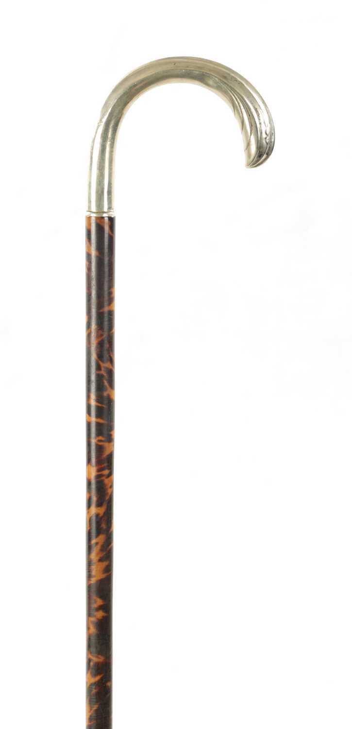 A 19TH CENTURY TORTOISESHELL VENEERED AND SILVER TOPPED WALKING STICK