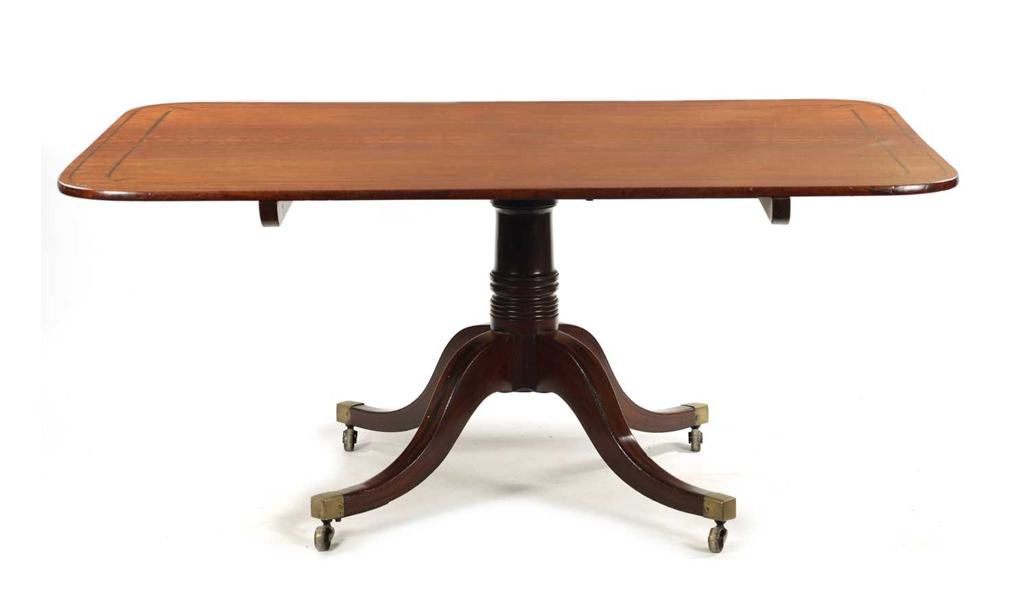 A GOOD REGENCY MAHOGANY AND EBONY INLAID PEDESTAL DINING TABLE OF LARGE SIZE