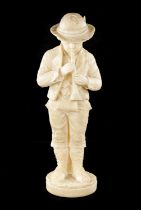A 19TH CENTURY CARVED ALABASTER FIGURE OF A BOY PLAYING AN INSTRUMENT