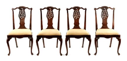 A RARE SET OF FOUR MID 18TH CENTURY OAK AND WALNUT VENEERED IRISH DINING CHAIRS WITH UNUSUAL ROCOCO