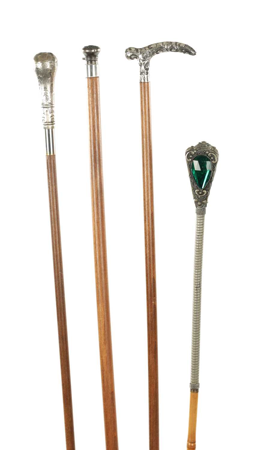 A COLLECTION OF FOUR LATE 19TH CENTURY SILVER AND WHITE METAL TOPPED WALKING STICKS