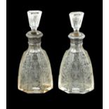 A NEAR PAIR OF 19TH CENTURY SILVER TOPPED CUT GLASS DECANTERS