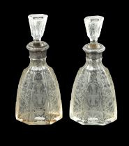 A NEAR PAIR OF 19TH CENTURY SILVER TOPPED CUT GLASS DECANTERS