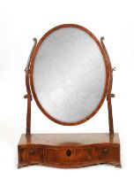 A GEORGE III MAHOGANY SERPENTINE DRESSING TABLE MIRROR