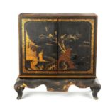 AN ENGLISH REGENCY CHINOISERIE DECORATED LACQUERWORK CABINET ON STAND