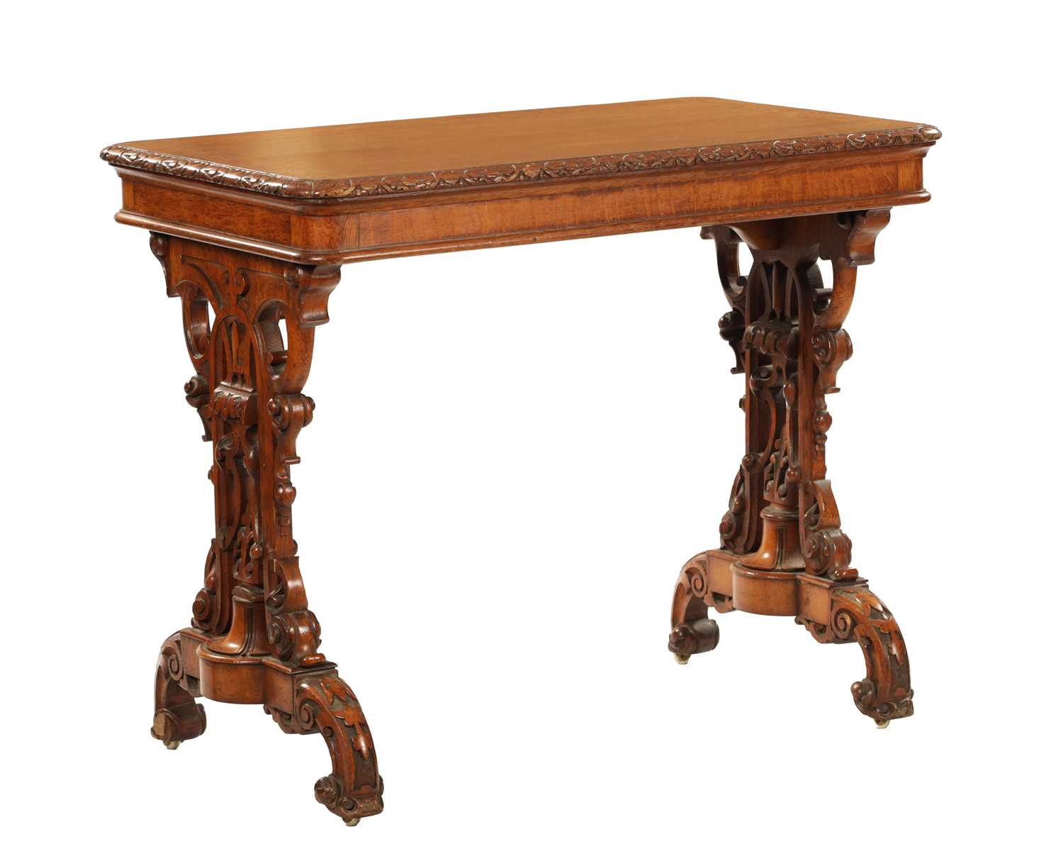 A 19TH CENTURY CARVED AND INLAID OAK LIBRARY TABLE BY LAMB MANCHESTER