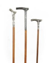 A COLLECTION OF THREE SMALL 19TH CENTURY SILVER TOPPED WALKING STICKS