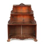 A SMALL REGENCY SIMULATED MAHOGANY STEPPED OPEN BOOKCASE