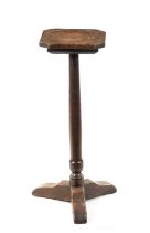 AN EARLY 18TH CENTURY OAK CANDLE STAND WITH DISHED TOP