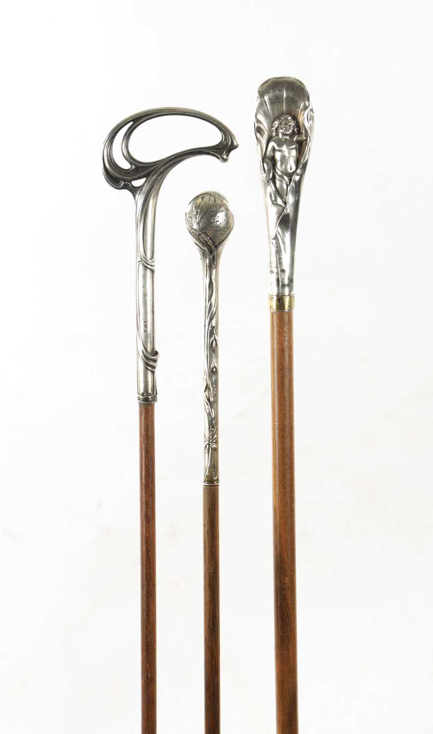 A COLLECTION OF THREE ART NOUVEAU SILVER TOPPED WALKING STICKS