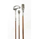 A COLLECTION OF THREE ART NOUVEAU SILVER TOPPED WALKING STICKS