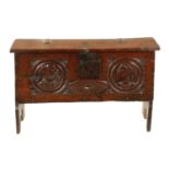 AN IMPORTANT 17TH CENTURY CARVED OAK PLANK COFFER WITH CARVED ROMANESQUE HEADS