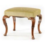 A GEORGE I WALNUT UPHOLSTERED STOOL