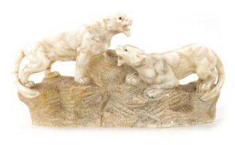 A 19TH CENTURY CARVED ALABASTER SCULPTURE OF TWO LIONS
