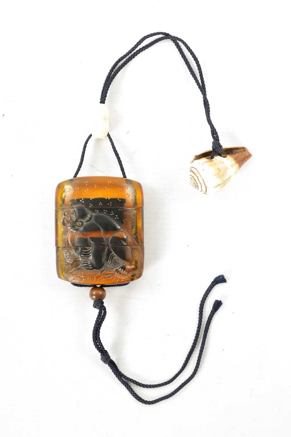 A 19TH CENTURY JAPANESE CARVED AMBER INRO