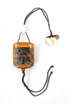 A 19TH CENTURY JAPANESE CARVED AMBER INRO
