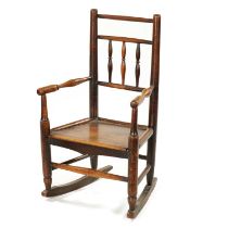 A 19TH CENTURY ELM CHILD'S SPINDLE BACK ROCKING CHAIR