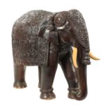 A LARGE EARLY 20TH CENTURY CARVED HARDWOOD ELEPHANT