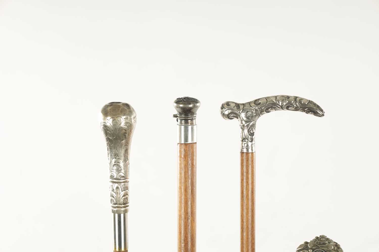 A COLLECTION OF FOUR LATE 19TH CENTURY SILVER AND WHITE METAL TOPPED WALKING STICKS - Image 4 of 6