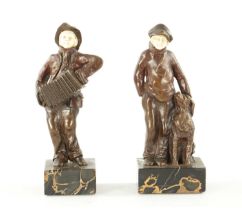 A PAIR OF ARTS AND CRAFTS BRONZE AND IVORY FIGURES