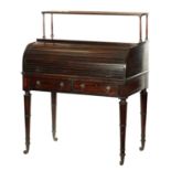 A REGENCY FIGURED MAHOGANY AND EBONY STRUNG TAMBOUR FRONT CYLINDER DESK