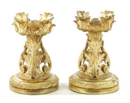 A PAIR OF EARLY 19TH CENTURY GILT ORMOLU FIRE DOGS