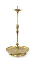 A 19TH CENTURY EASTERN BRASS CANDLESTICK