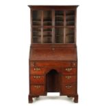 AN UNUSUAL QUEEN ANNE OAK KNEEHOLE BUREAU BOOKCASE