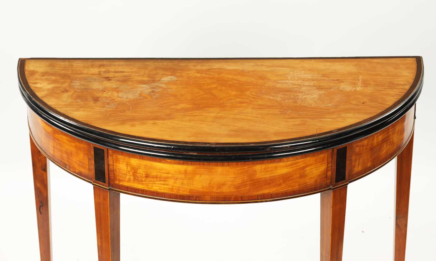 A GEORGE III SATINWOOD AND INLAID EBONISED DEMI LUNE FOLD OVER CARD TABLE - Image 4 of 10