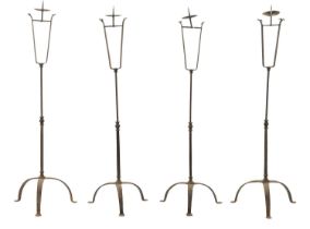 A SET OF FOUR IRONWORK CHURCH FLOOR STANDING CANDLESTICKS