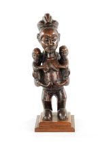 AN ANTIQUE CARVED HARDWOOD YAKA MATERNITY CONGO FIGURE