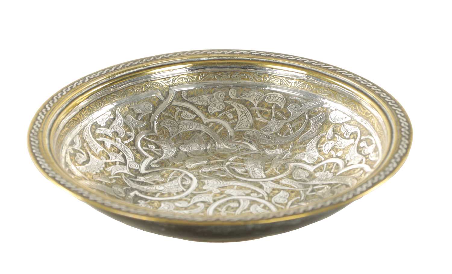 AN 18TH/19TH CENTURY MIDDLE EASTERN CAST BRASS AND SILVER INLAY SHALLOW BOWL