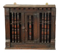A MID 17TH CENTURY OAK LIVERY HANGING CUPBOARD