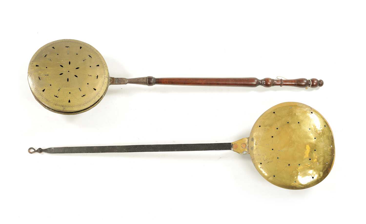 A 17TH CENTURY BRASS WARMING PAN AND AN 18TH CENTURY BRASS PIERCED WARMING PAN