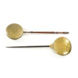 A 17TH CENTURY BRASS WARMING PAN AND AN 18TH CENTURY BRASS PIERCED WARMING PAN