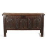 A LARGE 17TH CENTURY CARVED THREE PANELLED OAK COFFER