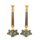 A PAIR OF REGENCY BRONZE AND ORMOLU CANDLESTICKS WITH LATER OIL LAMP FITTINGS