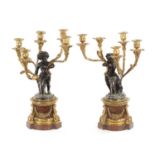 A GOOD PAIR OF ORMOLU AND BRONZE CHERUB FIVE BRANCH CANDELABRA